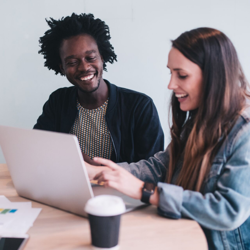 Employees collaborating at computers.