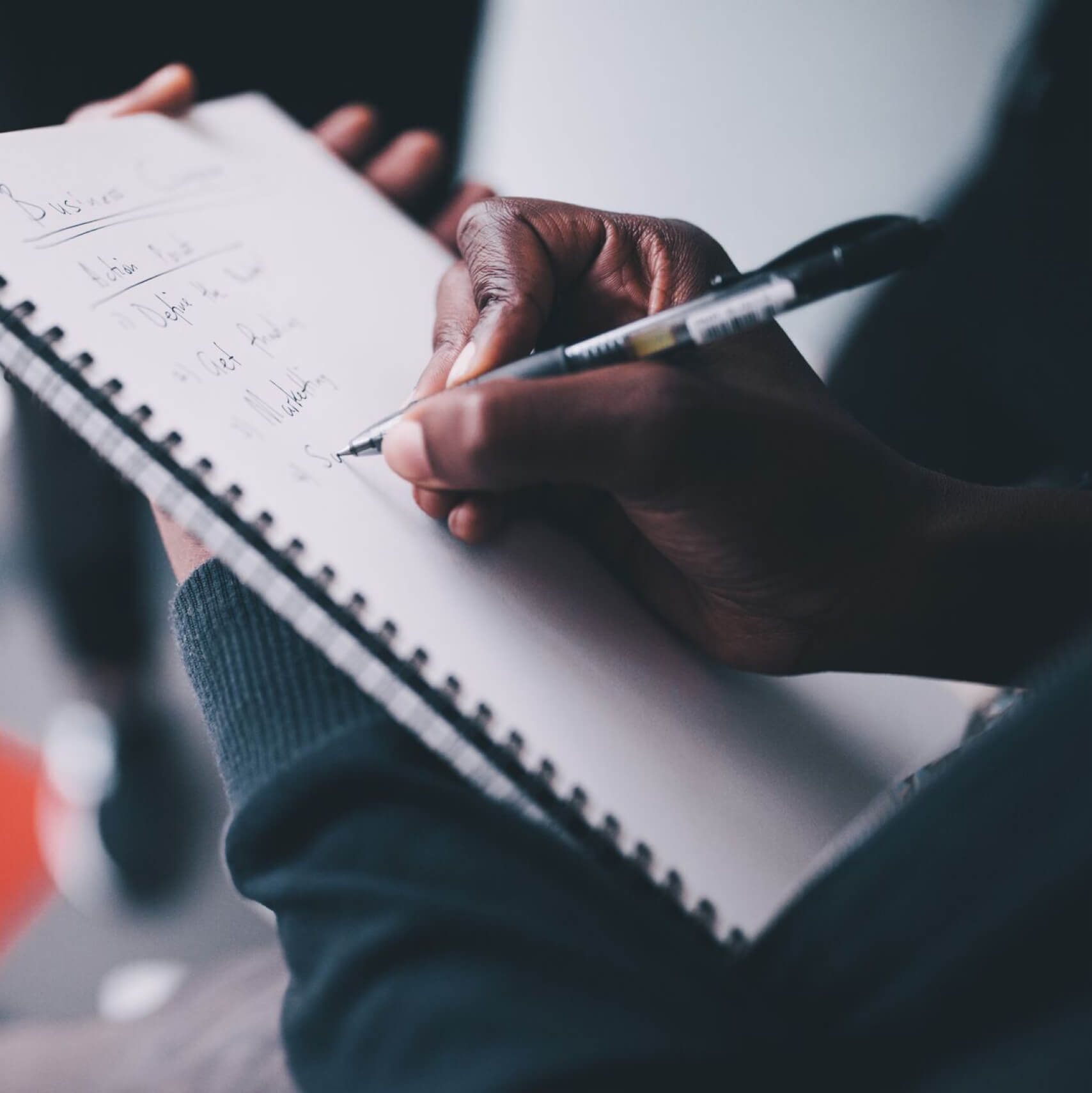 Employee taking notes at a meeting.