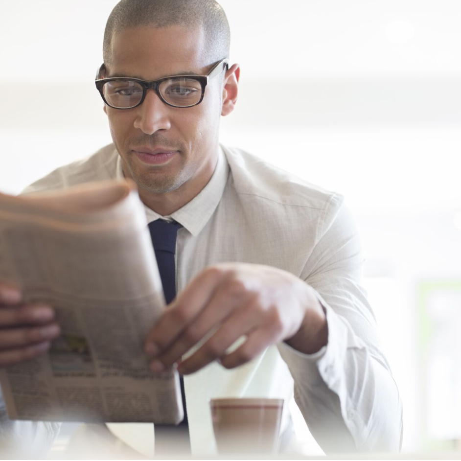 Employee reading article in newspaper.