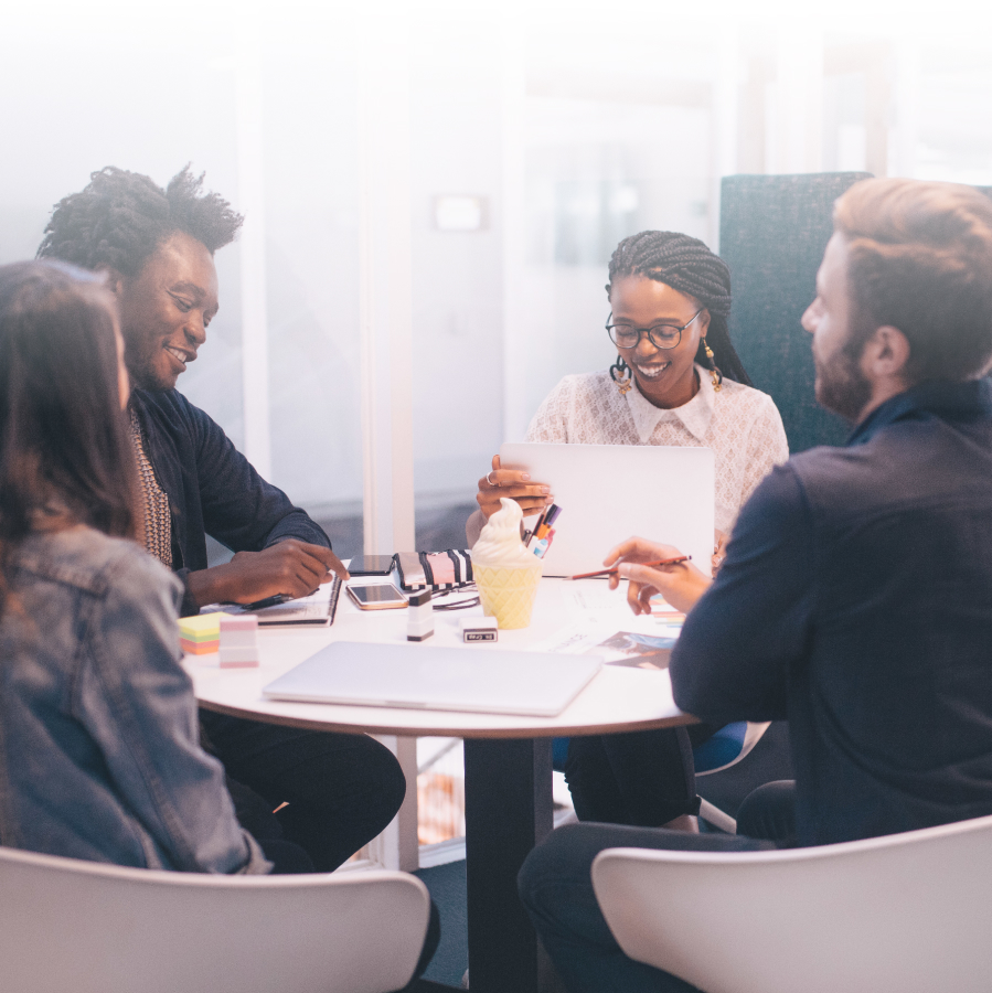 Employees and business owners meeting at a table.