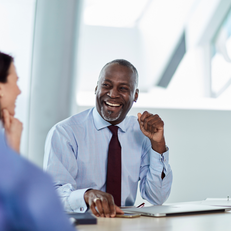 Employees and business owners meeting at a table.